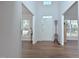 Bright foyer with light-colored walls, gleaming hardwood floors, and a coat rack near the front door at 1056 Evening Shade Ave, Rolesville, NC 27571
