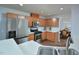 Modern kitchen with stainless steel appliances, wood cabinets, and quartz countertops, plus a double sink at 1056 Evening Shade Ave, Rolesville, NC 27571