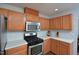 Well-lit kitchen featuring wooden cabinets, stainless steel appliances, and white countertops at 1056 Evening Shade Ave, Rolesville, NC 27571
