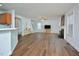 Spacious living room with hardwood floors, fireplace, ceiling fan, and a seamless connection to the kitchen at 1056 Evening Shade Ave, Rolesville, NC 27571