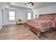 Spacious main bedroom with wood floors, tray ceiling, and a comfortable seating area at 1056 Evening Shade Ave, Rolesville, NC 27571