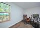 Home office with a leather desk chair, computer, and a window with wood blinds at 1056 Evening Shade Ave, Rolesville, NC 27571