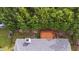 Aerial view showcasing a wooden deck amid lush trees with home's roof and adjacent landscaping at 107 Governors House Dr, Morrisville, NC 27560
