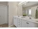 Bright bathroom features double sinks, white cabinetry, and framed mirrors with a separate glass enclosed shower at 107 Governors House Dr, Morrisville, NC 27560