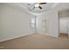 Spacious carpeted bedroom with a decorative ceiling fan and an ensuite bath with a separate shower at 107 Governors House Dr, Morrisville, NC 27560