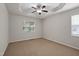 Bright, carpeted bedroom featuring natural light, neutral paint, and a ceiling fan at 107 Governors House Dr, Morrisville, NC 27560