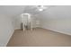 Spacious bonus room featuring neutral carpet and a ceiling fan, perfect for flexible living at 107 Governors House Dr, Morrisville, NC 27560