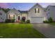 Charming home with manicured lawn, two-car garage, and lovely landscaping at dusk at 107 Governors House Dr, Morrisville, NC 27560