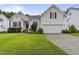 Charming home featuring a well-manicured lawn, two-car garage, and beautiful landscaping at 107 Governors House Dr, Morrisville, NC 27560