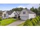 Charming home with manicured lawn, two-car garage, and pretty landscaping at 107 Governors House Dr, Morrisville, NC 27560