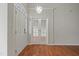 Elegant foyer with a decorative light fixture and gleaming wood floors at 107 Governors House Dr, Morrisville, NC 27560