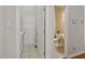 Bright hallway featuring tile floors, access to a laundry room and powder room, and a white exterior door at 107 Governors House Dr, Morrisville, NC 27560