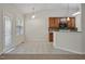 Bright eat-in kitchen with tile floors, wood cabinets, and rear door at 107 Governors House Dr, Morrisville, NC 27560