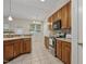 Well-lit kitchen with stainless steel appliances and wood cabinetry at 107 Governors House Dr, Morrisville, NC 27560