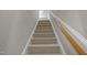 Carpeted staircase with wood handrail at 107 Governors House Dr, Morrisville, NC 27560