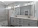 Bathroom featuring a double vanity, a large mirror, and a glass shower at 109 Drew St, Louisburg, NC 27549