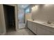 Bathroom featuring double vanity, tile floor, and walk-in shower with grey tile at 109 Drew St, Louisburg, NC 27549
