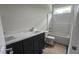Bathroom featuring double vanity, toilet, shower and bathtub with white fixtures at 109 Drew St, Louisburg, NC 27549