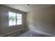 Bedroom with a large window that lets in natural light and neutral walls at 109 Drew St, Louisburg, NC 27549