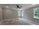 Spacious bedroom with a ceiling fan, two windows, and light-colored walls at 109 Drew St, Louisburg, NC 27549