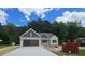 Charming single-Gathering home features a welcoming facade and attached garage at 109 Drew St, Louisburg, NC 27549