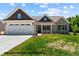 Charming single Gathering home with stone accents, siding, well manicured yard, and a two car garage at 109 Drew St, Louisburg, NC 27549