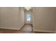 Hallway with neutral paint, ready for personalization, and leading to a bright, inviting space at 109 Drew St, Louisburg, NC 27549