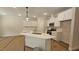Bright kitchen featuring white cabinets, stainless appliances, quartz countertops, and pendant lighting at 109 Drew St, Louisburg, NC 27549
