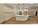 Bright kitchen featuring white cabinets, stainless appliances, quartz countertops, and pendant lighting at 109 Drew St, Louisburg, NC 27549