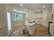 Open concept kitchen with white cabinetry, an island, stainless steel appliances, and hardwood flooring at 109 Drew St, Louisburg, NC 27549
