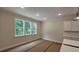 Open living room with a large window and natural light and cabinets at 109 Drew St, Louisburg, NC 27549