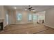 Spacious living room with a fireplace, hardwood flooring, ceiling fan, and open concept kitchen view at 109 Drew St, Louisburg, NC 27549