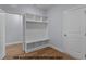 Mudroom featuring hardwood floors, built-in shelves, storage and a door at 109 Drew St, Louisburg, NC 27549