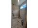 Walk-in shower with tile floor, tile walls, window, and a built-in seat at 109 Drew St, Louisburg, NC 27549