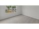 Bright, carpeted bedroom with a window overlooking the neighborhood at 109 Gabriel Ct, Wilson's Mills, NC 27520
