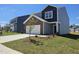 Well-manicured two-story home with attached two-car garage and freshly landscaped front yard at 109 Gabriel Ct, Wilson's Mills, NC 27520