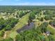 Stunning aerial view of a lush golf course with lake and residential area at 113 Feezor Ct, Clayton, NC 27527