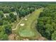 Aerial view featuring the lush green fairways and sand traps of the pristine golf course in a leafy, residential community at 113 Feezor Ct, Clayton, NC 27527