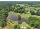 Scenic aerial view of a golf course, showcasing the lake and surrounding greenery at 113 Feezor Ct, Clayton, NC 27527