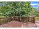 Relaxing backyard deck offers a serene view of the home's lush green space with mature trees at 113 Feezor Ct, Clayton, NC 27527
