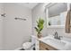 Stylishly appointed bathroom with modern vanity, decorative mirror, and green potted plant at 113 Feezor Ct, Clayton, NC 27527