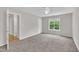 Large, carpeted bedroom featuring a ceiling fan, a window and a closet at 113 Feezor Ct, Clayton, NC 27527