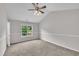 Carpeted bedroom offers a sunlit window and neutral paint for a calm, relaxing atmosphere at 113 Feezor Ct, Clayton, NC 27527