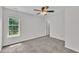 Carpeted bedroom featuring natural light and a ceiling fan creates a comfortable space at 113 Feezor Ct, Clayton, NC 27527