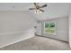 Bright bedroom featuring plush carpeting, neutral walls, and a sunlit window at 113 Feezor Ct, Clayton, NC 27527