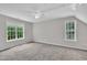 Carpeted room with two windows provides ample natural light and features a ceiling fan at 113 Feezor Ct, Clayton, NC 27527