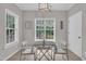 Dining room with lots of natural light, a hanging light fixture and wood flooring at 113 Feezor Ct, Clayton, NC 27527