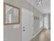 Clean entryway with a neutral palette, featuring a large mirror and modern lighting at 113 Feezor Ct, Clayton, NC 27527