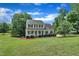 Charming two-story home boasts a welcoming front porch, manicured lawn, and lush landscaping, creating an inviting curb appeal at 113 Feezor Ct, Clayton, NC 27527