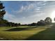 Scenic view of the lush green fairway on a sunny day at the golf course at 113 Feezor Ct, Clayton, NC 27527